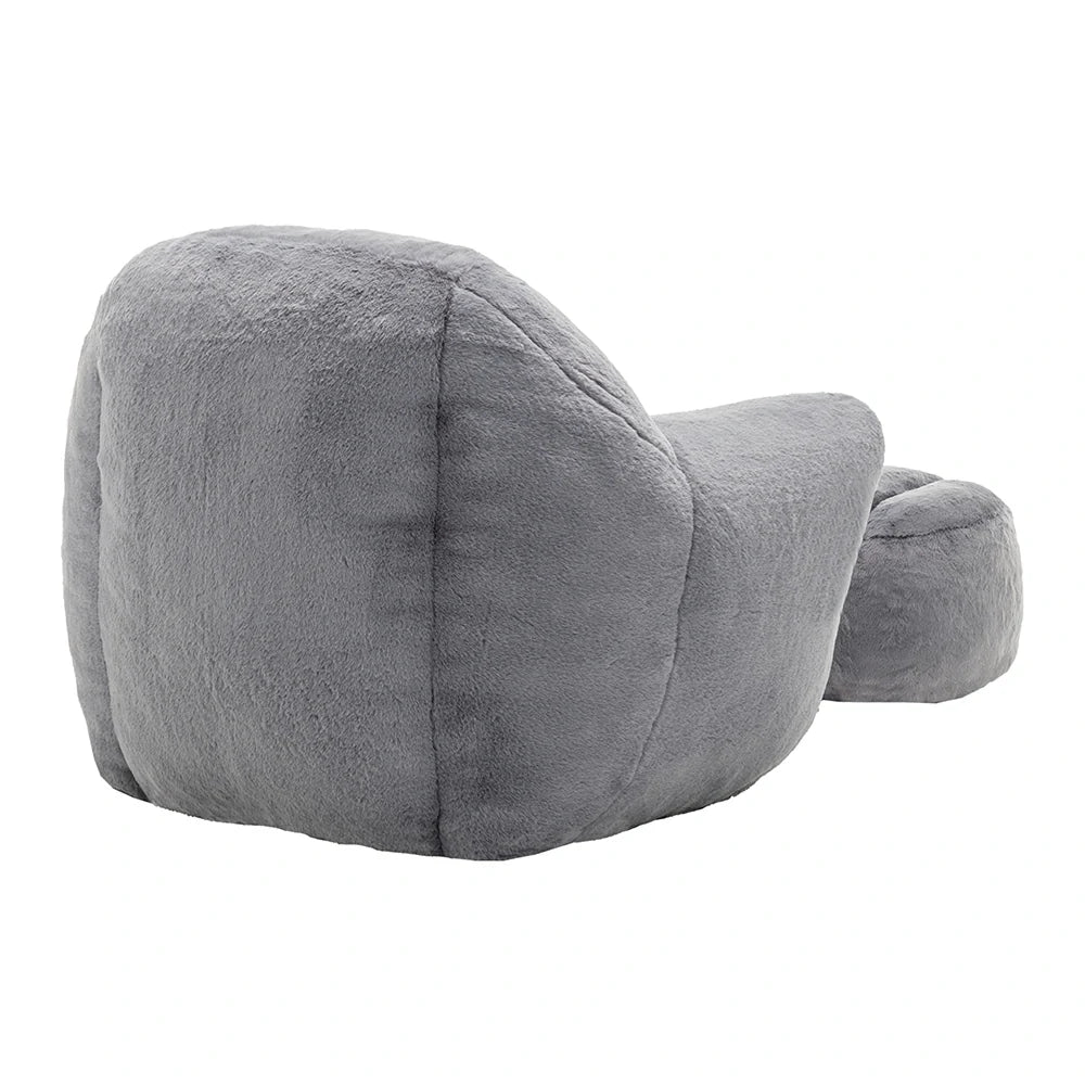 Back view of plush grey armchair with ottoman