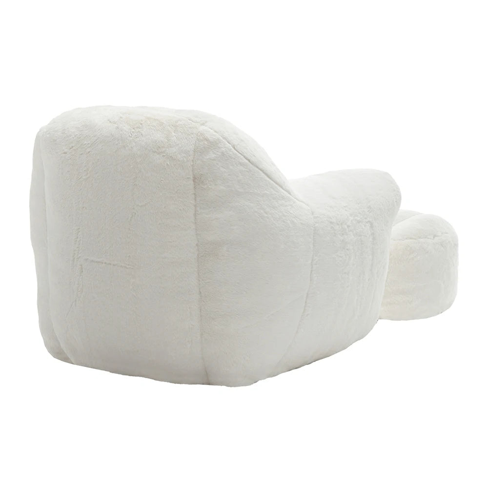Back view of plush white armchair with ottoman