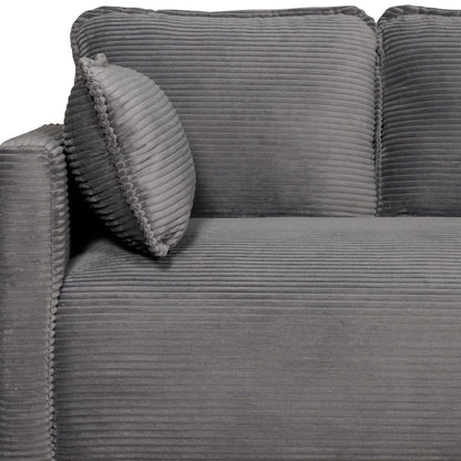 Close up of armrest and pillow on grey corduroy sofa