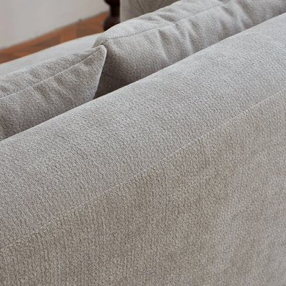 Close up of durable textured fabric and stitching on grey sofa