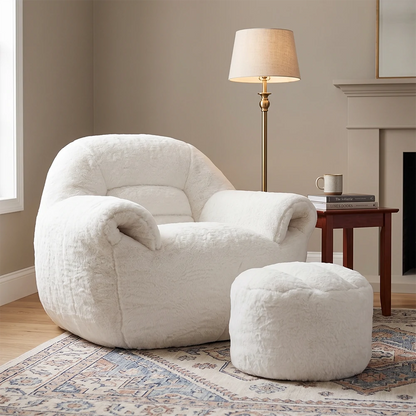 Plush white armchair with matching ottoman in a modern living room