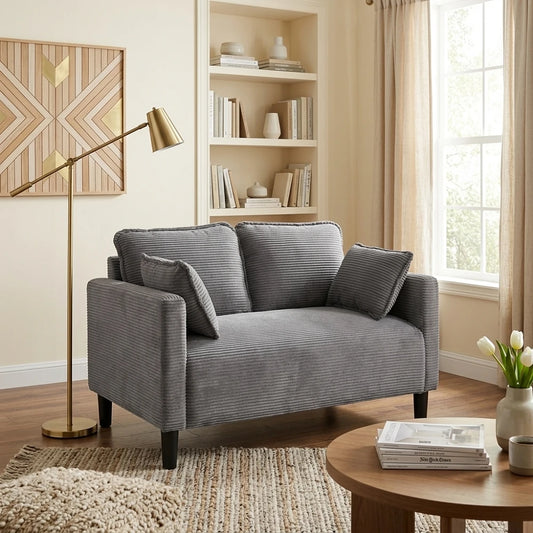 Side angle of grey corduroy sofa next to floor lamp