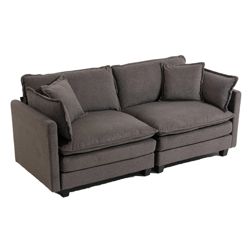 Side angle of plush grey sofa with cushions