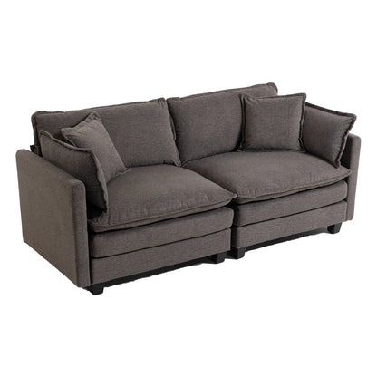 Side angle of plush grey sofa with cushions