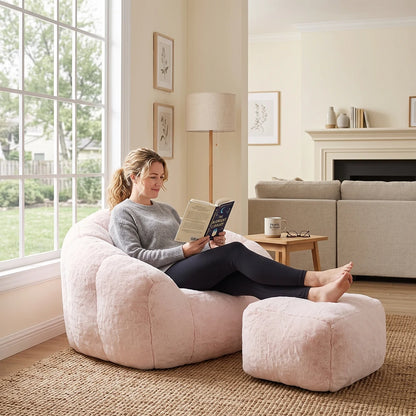Woman relaxing in pink plush bean bag chair reading a book
